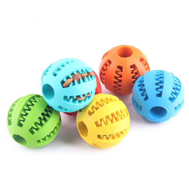 Colorful dog toy balls with textured surfaces on a white background