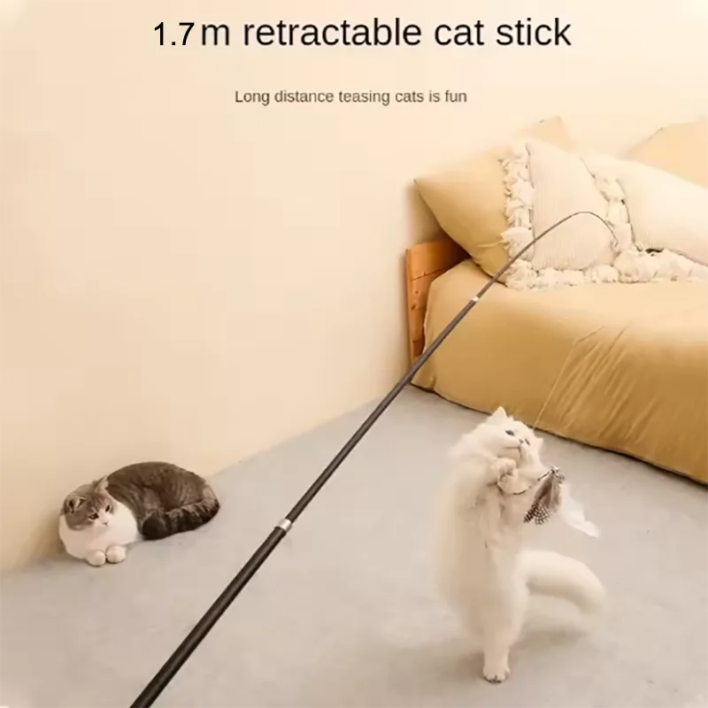 Two cats playing with a 1.7m retractable cat stick on a bed.