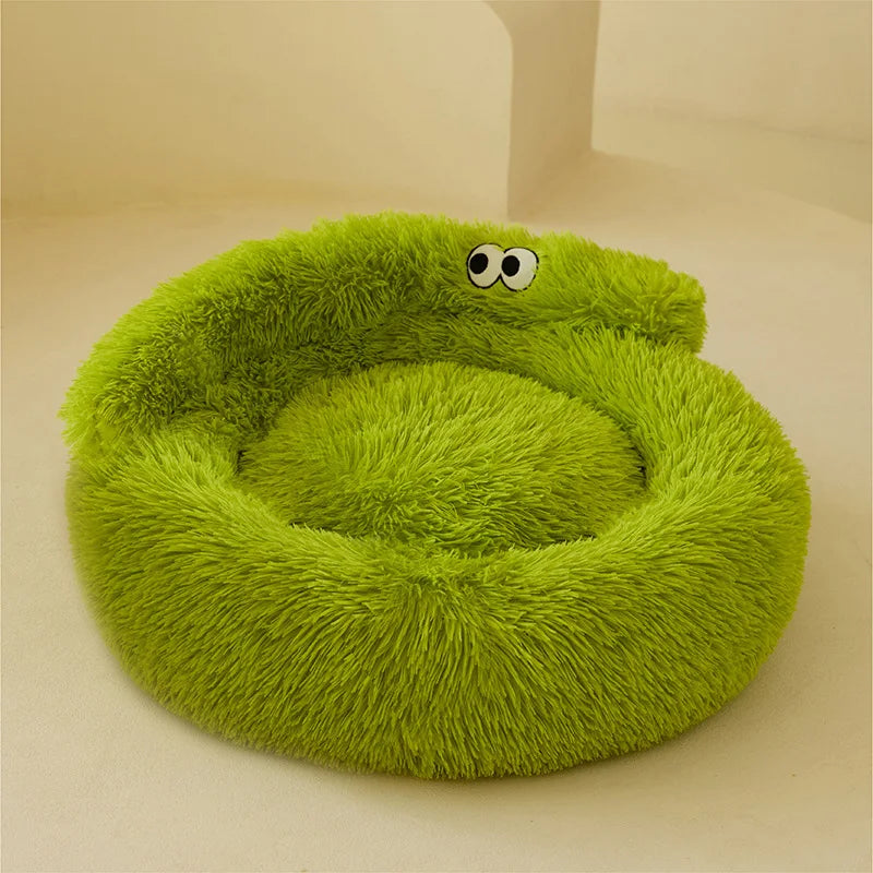 Green fluffy pet bed with googly eyes on a beige background