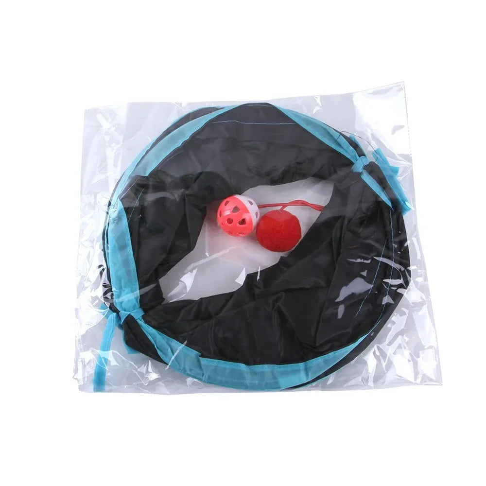 Packaged pet toy with a black and blue container and red and white balls on a white background