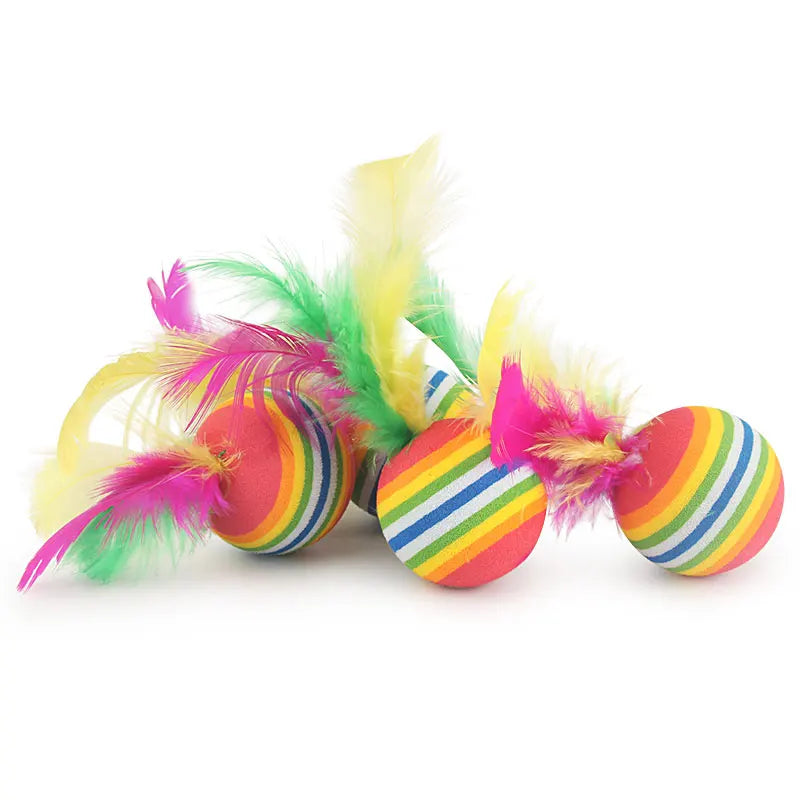 Colorful striped rubber ball with feathers on a white background