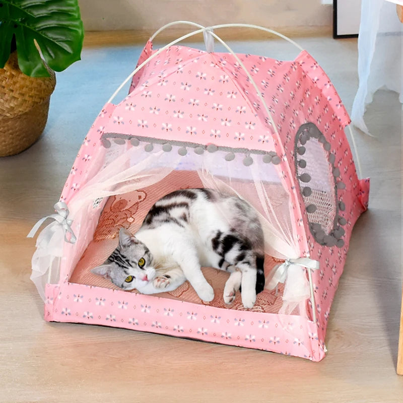 Pink pet tent with a cat inside on a wooden floor