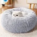 Fluffy gray pet bed on a wooden floor