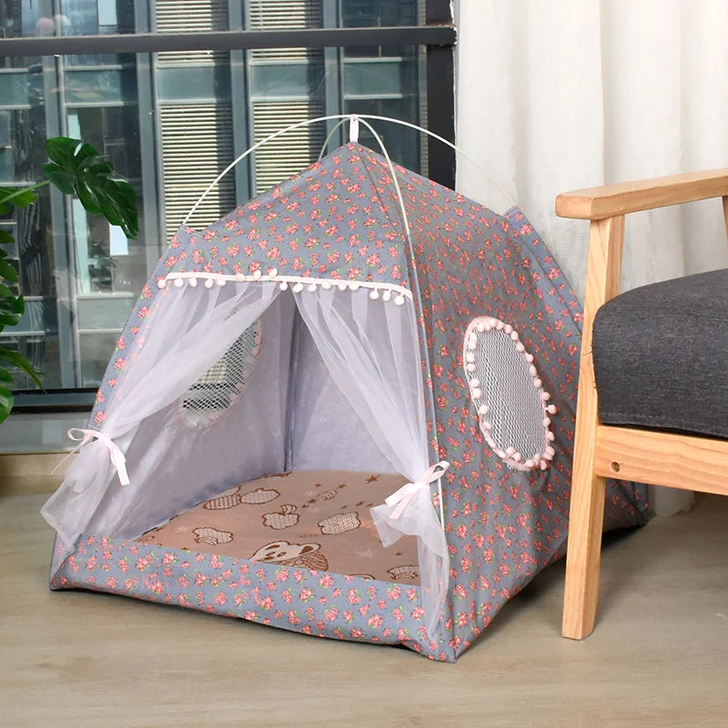 Cat's play tent with floral pattern on a wooden floor.