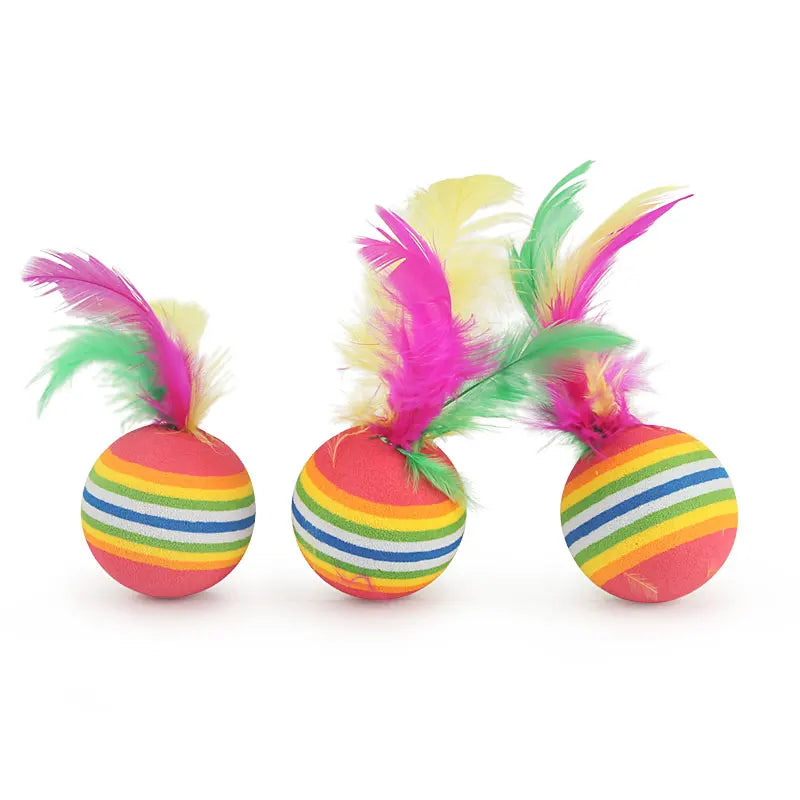 Three colorful striped balls with feathers on a white background