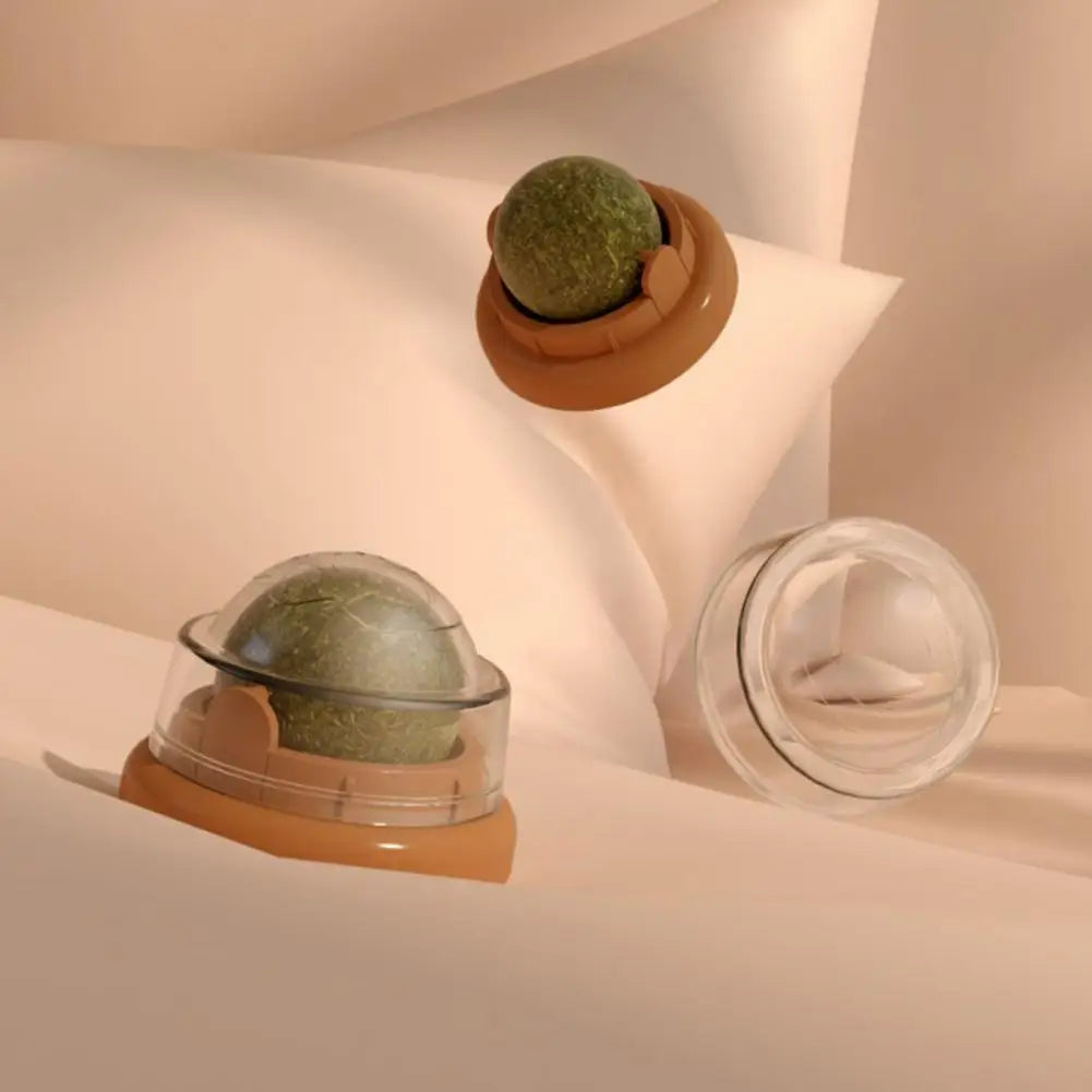 Three green spherical objects in clear domes on a soft beige background