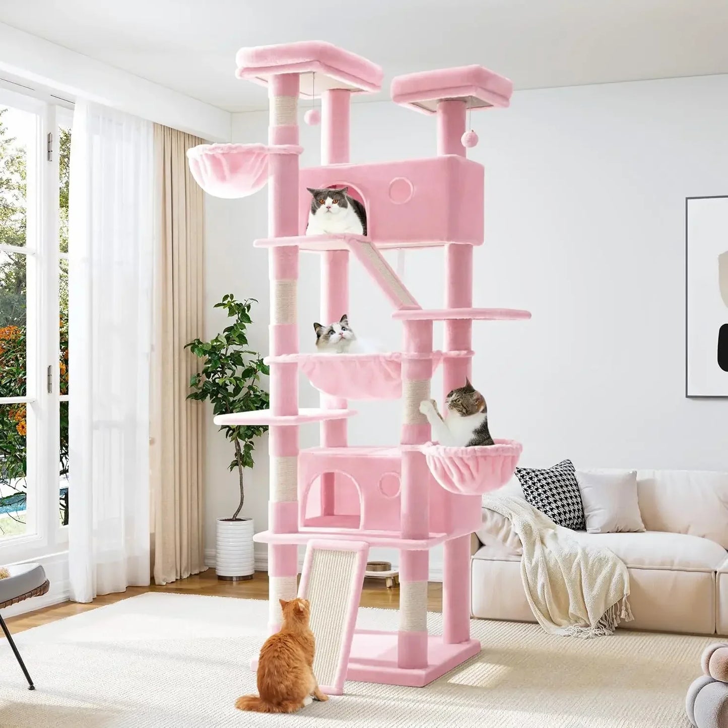Pink multi-level cat tree with cats in a living room setting