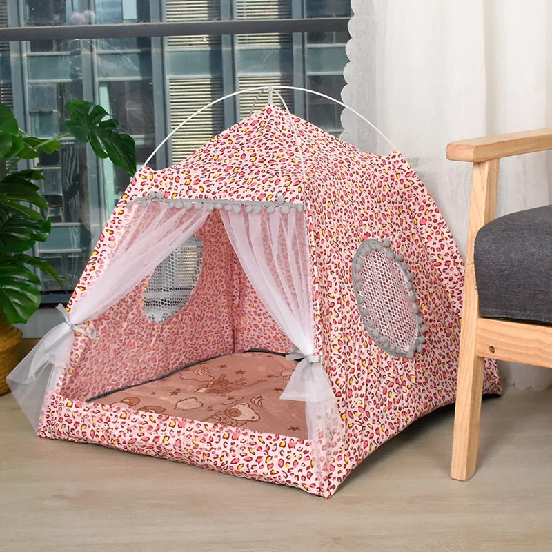 Pink floral pet tent with a white canopy on a wooden floor.