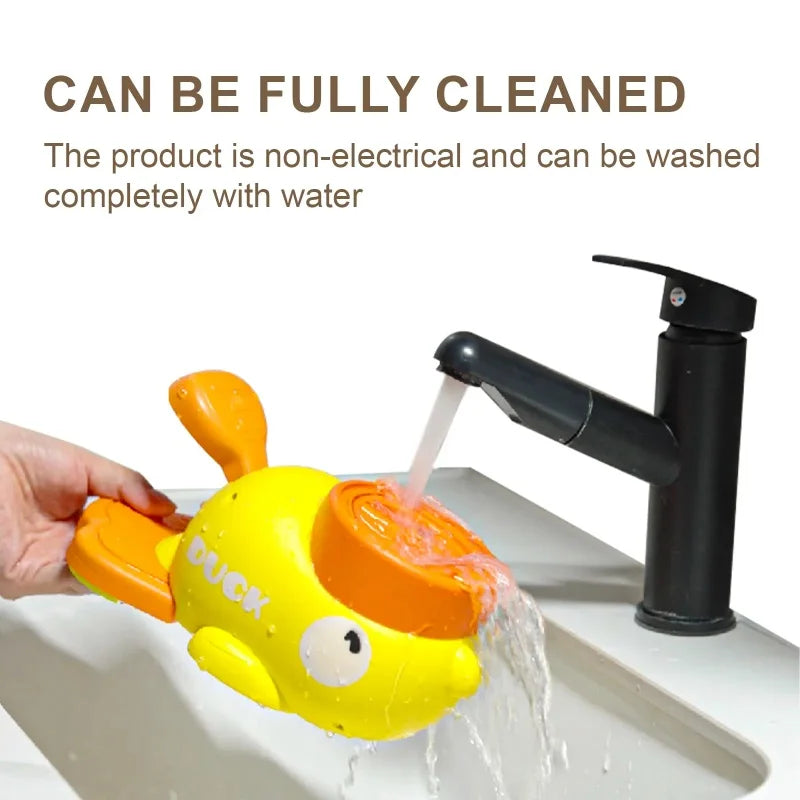 Yellow duck toy with an orange beak being rinsed under a faucet, text indicating it is non-electrical and can be washed with water.