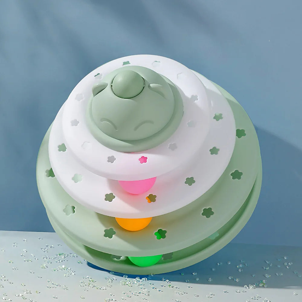 tiered cat toy with colorful balls on a blue background