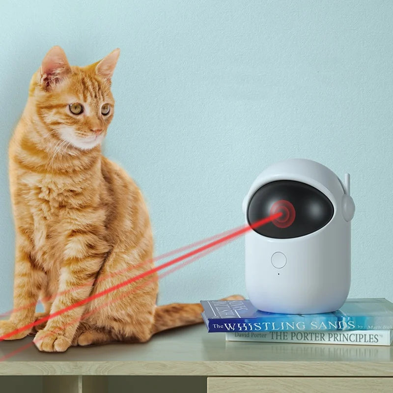 Cat interacting with a laser pointer device on a table