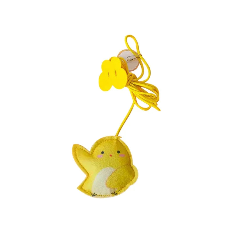 Yellow plush chick with a yellow string on a white background