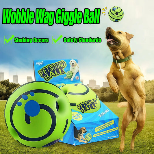 Dog playing with a green 'Wobble Wag Giggle Ball' toy with packaging and a dog jumping in the background.